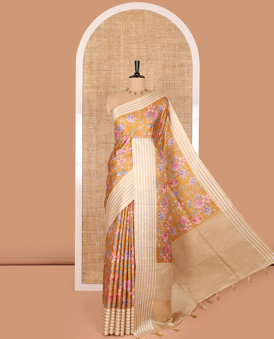 Mustard colorful floral motifs printed fancy tussar saree, contrast triangle motifs border, striped pallu, and a contrast striped blouse