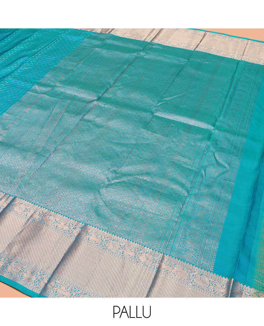 Blue Vasundhara Silk Saree, Beautifully Bedecked with Zig-Zag Stripes All Over Its Body, Highlighted by a Zari Border of Rekku, Muthu, Neli, Mayil, and Yaali Designs, Grand Jaal Pallu, and Paired with a Matching Blouse
