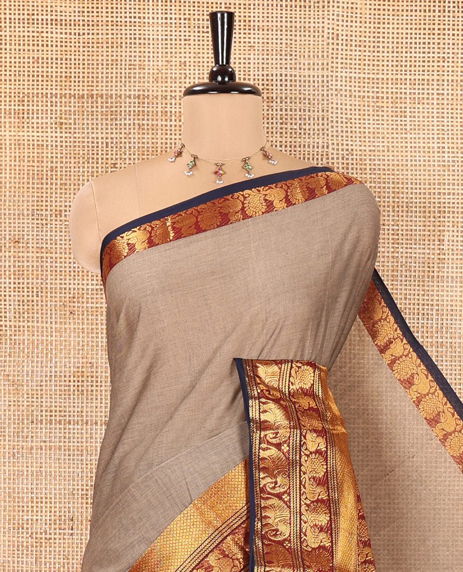 Beige Plain Chettinad Cotton Saree, Complemented by Contrast Traditional Zari Border of Peacock and Elephant Designs, Zari Striped Pallu, and Paired with a Matching Blouse