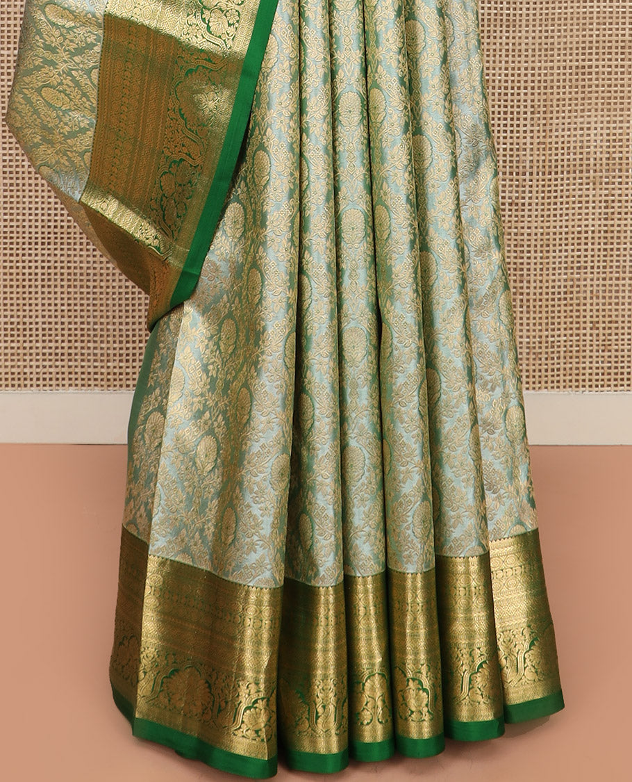 Green Kanchipuram Silk Saree Embellished with Jacquard Design, Highlighted by a Contrast Border of Thilakam, Muthu, Rekku, Manga, Chakram, and Floral Designs, Majestically Woven Pallu Steeped with Chakram Designs, and Paired with a Matching Blouse