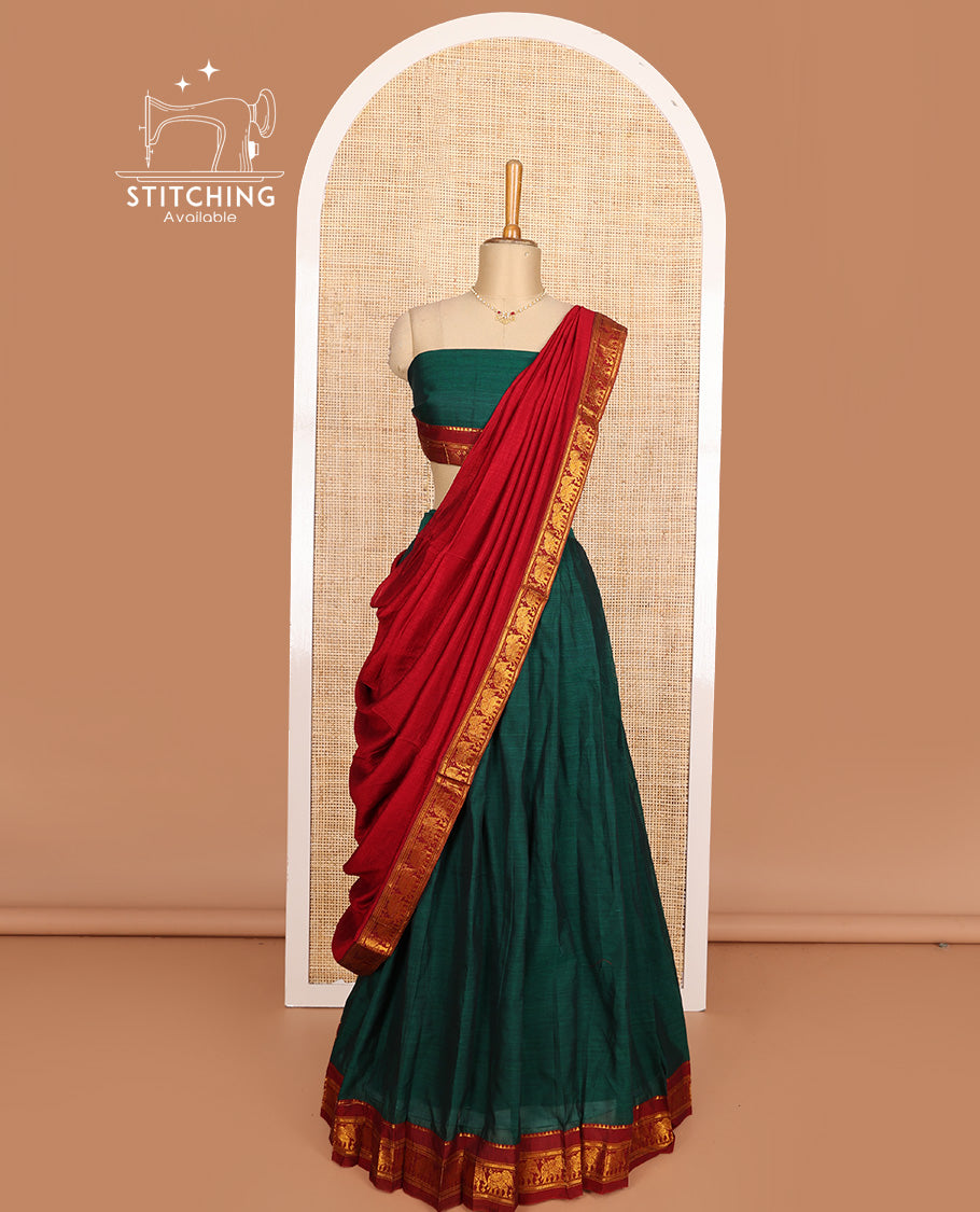 Green cotton half-saree, plain with contrast elephant motif bordered skirt, matching blouse, and contrast elephant motif bordered dhavani