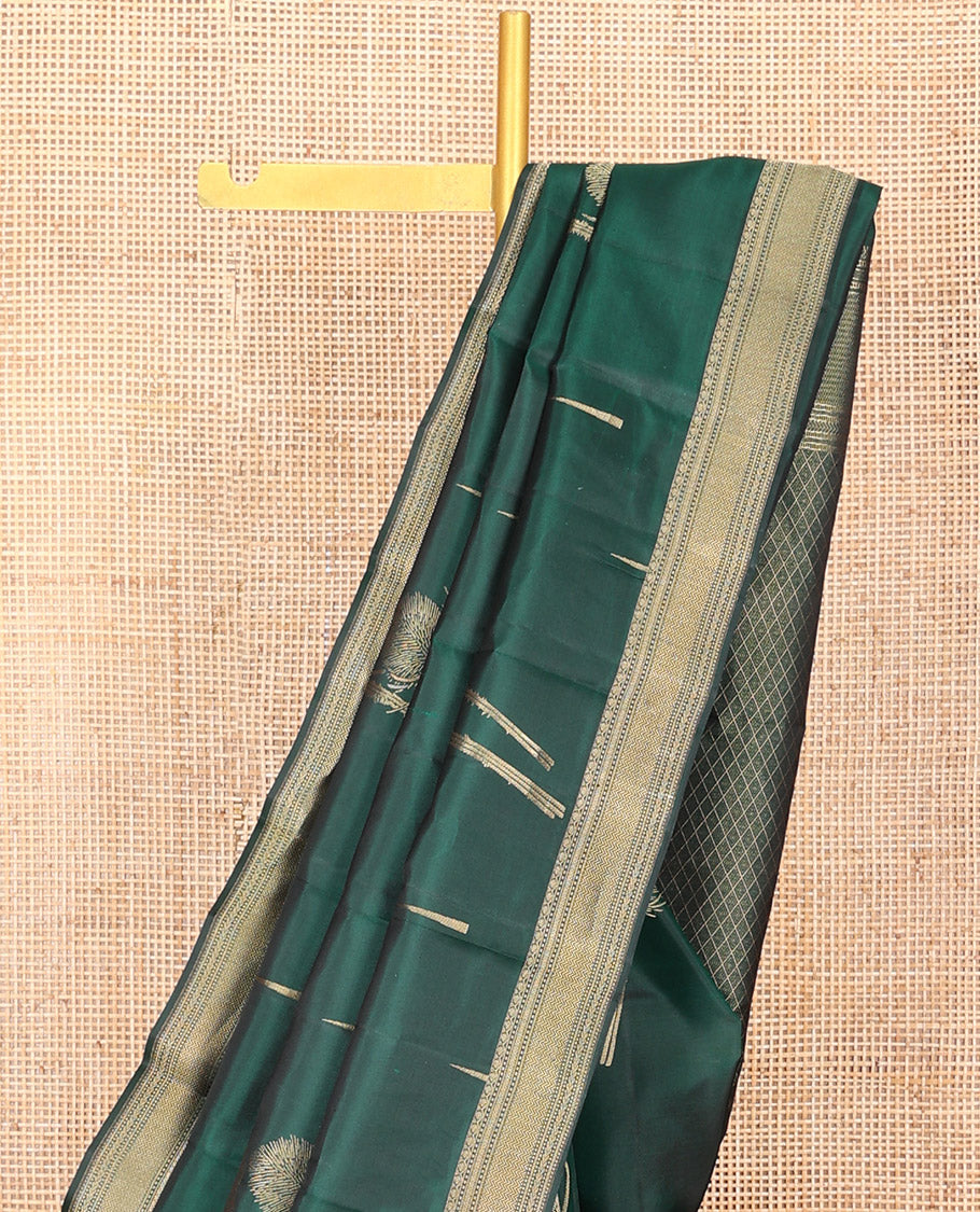 Green Vasundhara Silk Saree Creatively Designed with Thazampoo Rekku Buttas and Vel Buttas, Highlighted with a Zari Border of Manga, Muthu, Kathir, Neli, and Vanki Designs, Subtly Sparkled Pallu of Jaal Design, and Paired with a Matching Blouse