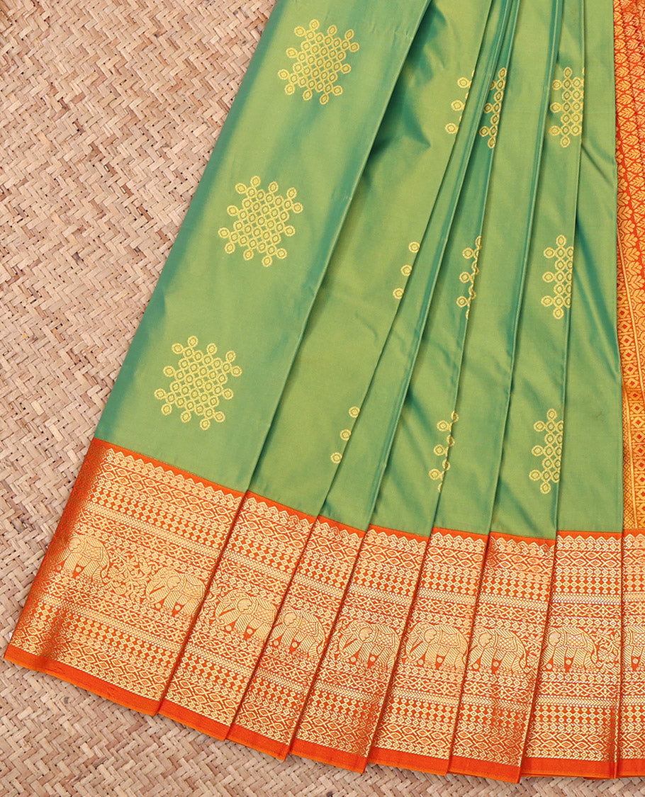 Green Budget Silk Saree Features Kolam Buttas, Complemented by a Contrast Traditional Zari Border, Grand Pallu, and a Contrast Blouse