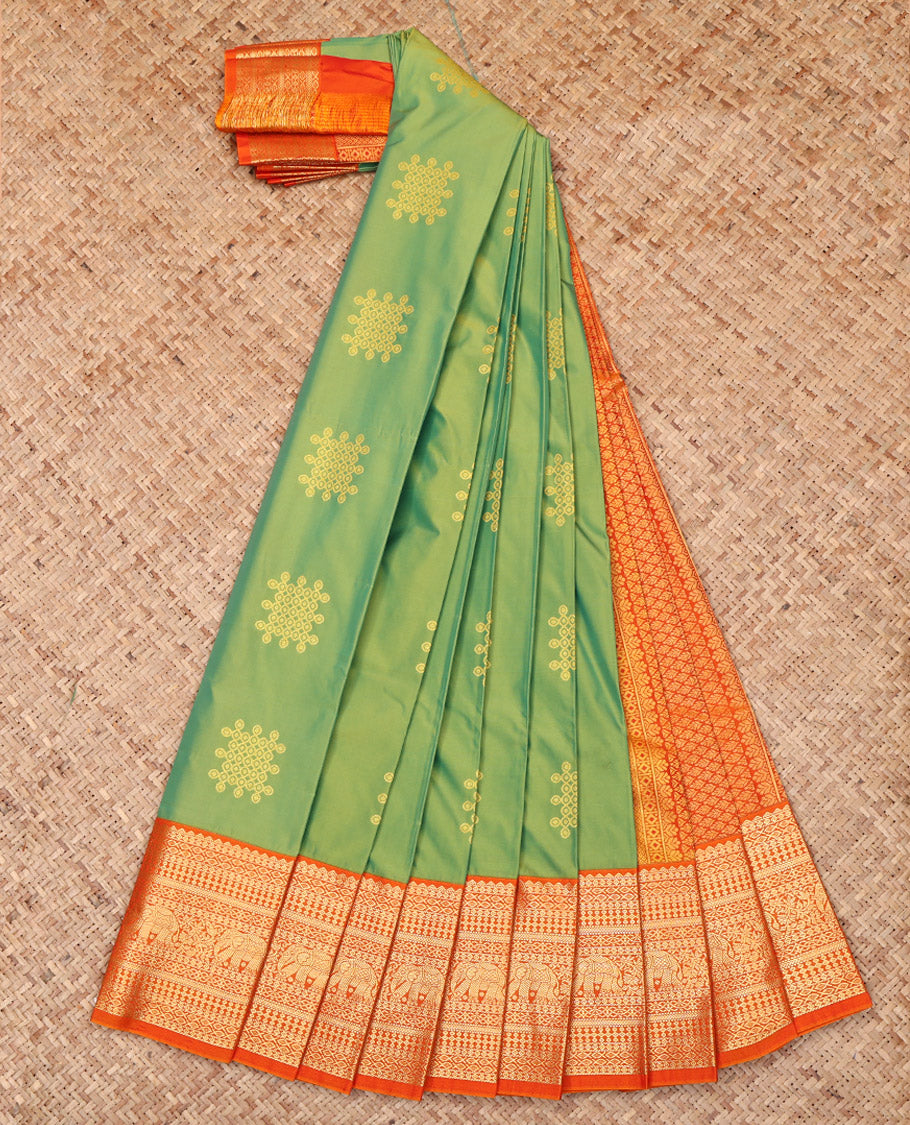 Green Budget Silk Saree Features Kolam Buttas, Complemented by a Contrast Traditional Zari Border, Grand Pallu, and a Contrast Blouse