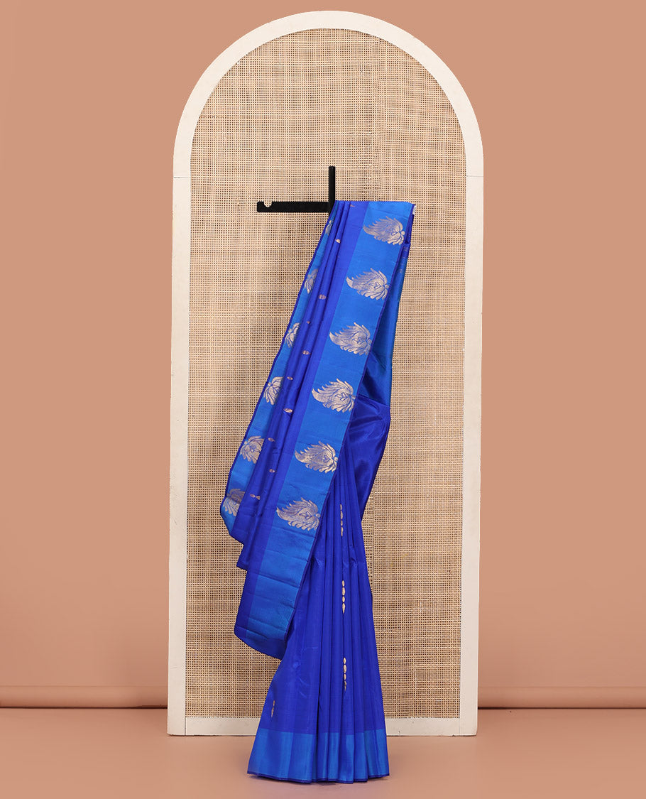 Royal Blue Kanchipuram Silk Saree Adorned with Zari Buttas, Complemented by a Contrast Border of Leaf Zari Designs, Sparsely Zari Woven Pallu, and Paired with a Contrast Blouse