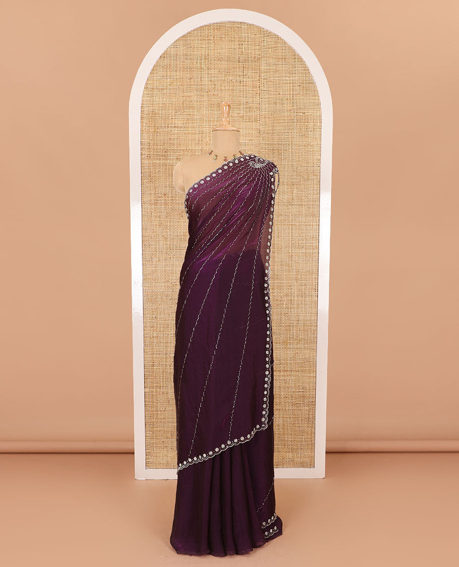 Wine micro-stone work fendy chiffon saree with paisley stone work on its shoulder, a scallop stone work border, a butterfly style pallu, and a matching stone work blouse