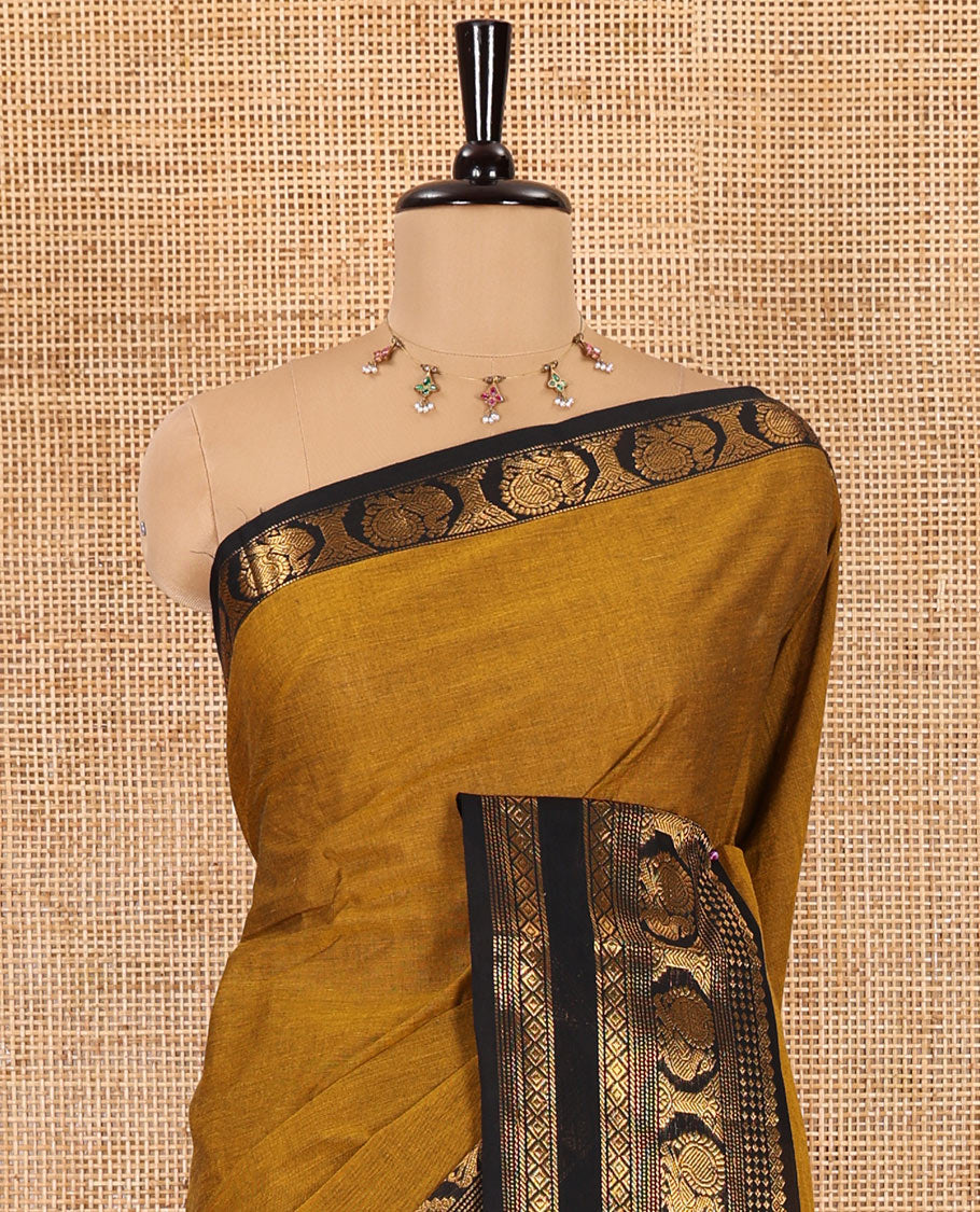 Gold plain design chettinad cotton saree, contrast traditional zari border of peacock motifs, striped pallu, and a matching blouse