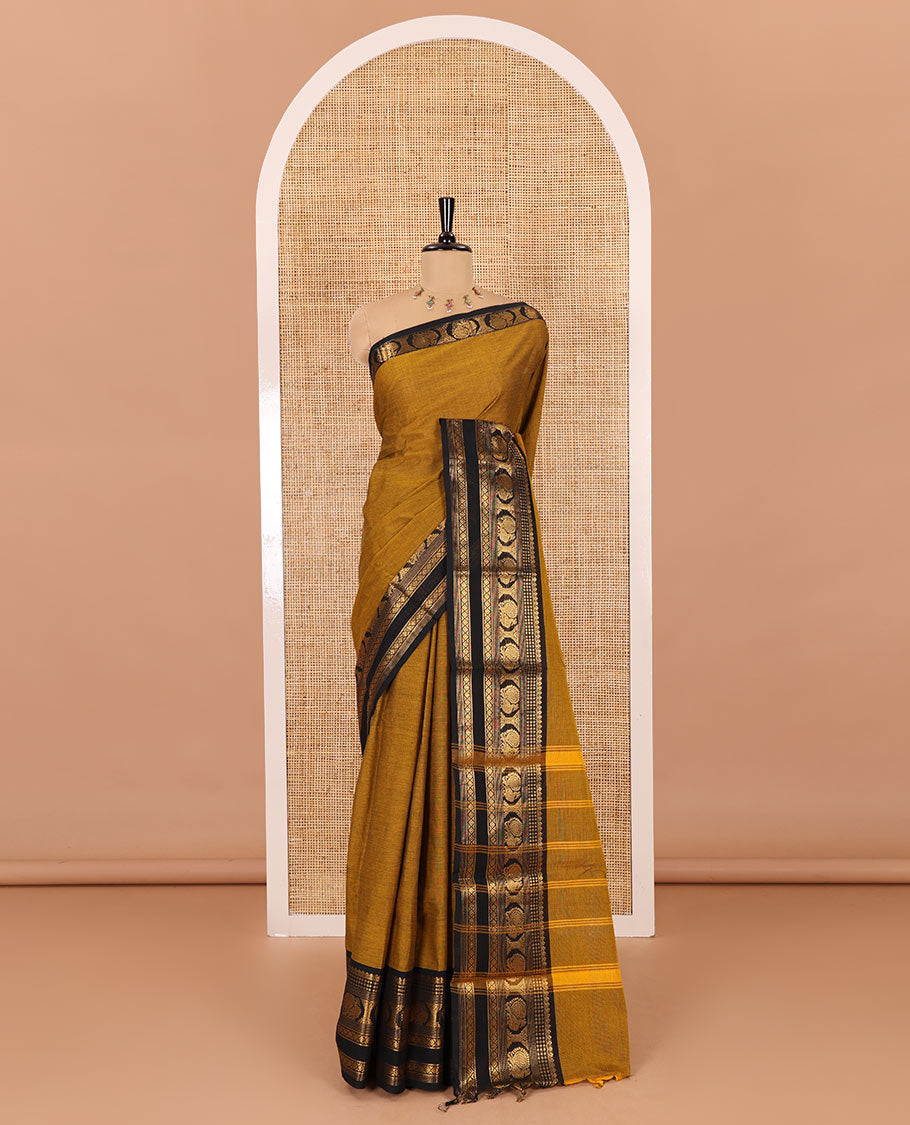 Gold plain design chettinad cotton saree, contrast traditional zari border of peacock motifs, striped pallu, and a matching blouse