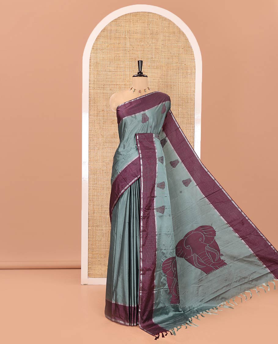 Green Soft Silk Saree, Mesmerized with Elephant Motifs All Over Its Body, Complemented by a Contrast Zari Striped Border, Pallu Depicts Big Elephant Motifs, and Paired with a Matching Blouse