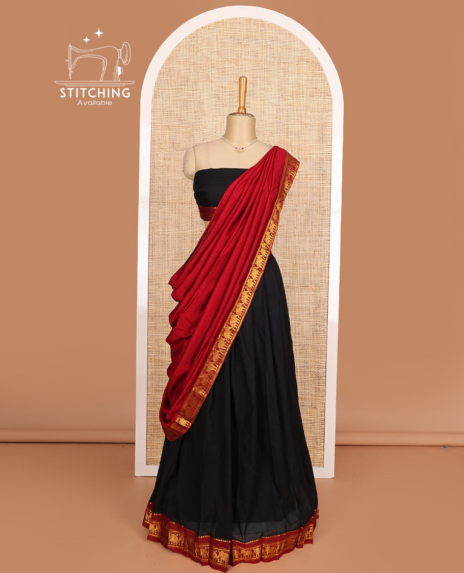 Black cotton half-saree, plain with contrast elephant motif bordered skirt, matching blouse, and contrast elephant motif bordered dhavani