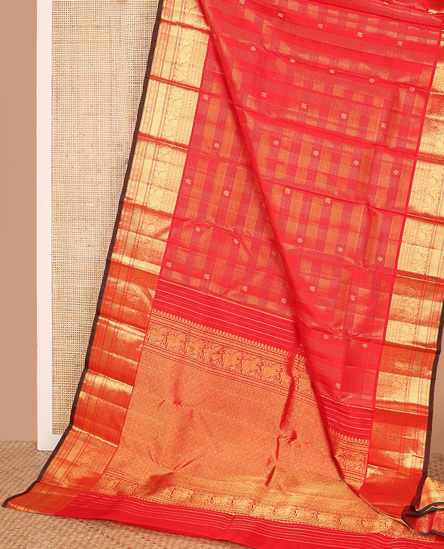 Red zari checked and buttas Kanchipuram silk saree, zari border of thilakam mokku, banaras, kamalam, mayil, and chakram designs, and jaal pallu