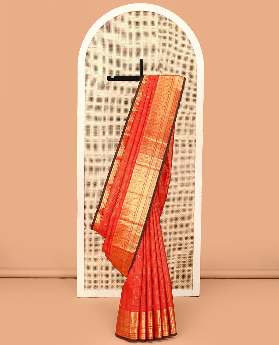 Red zari checked and buttas Kanchipuram silk saree, zari border of thilakam mokku, banaras, kamalam, mayil, and chakram designs, and jaal pallu