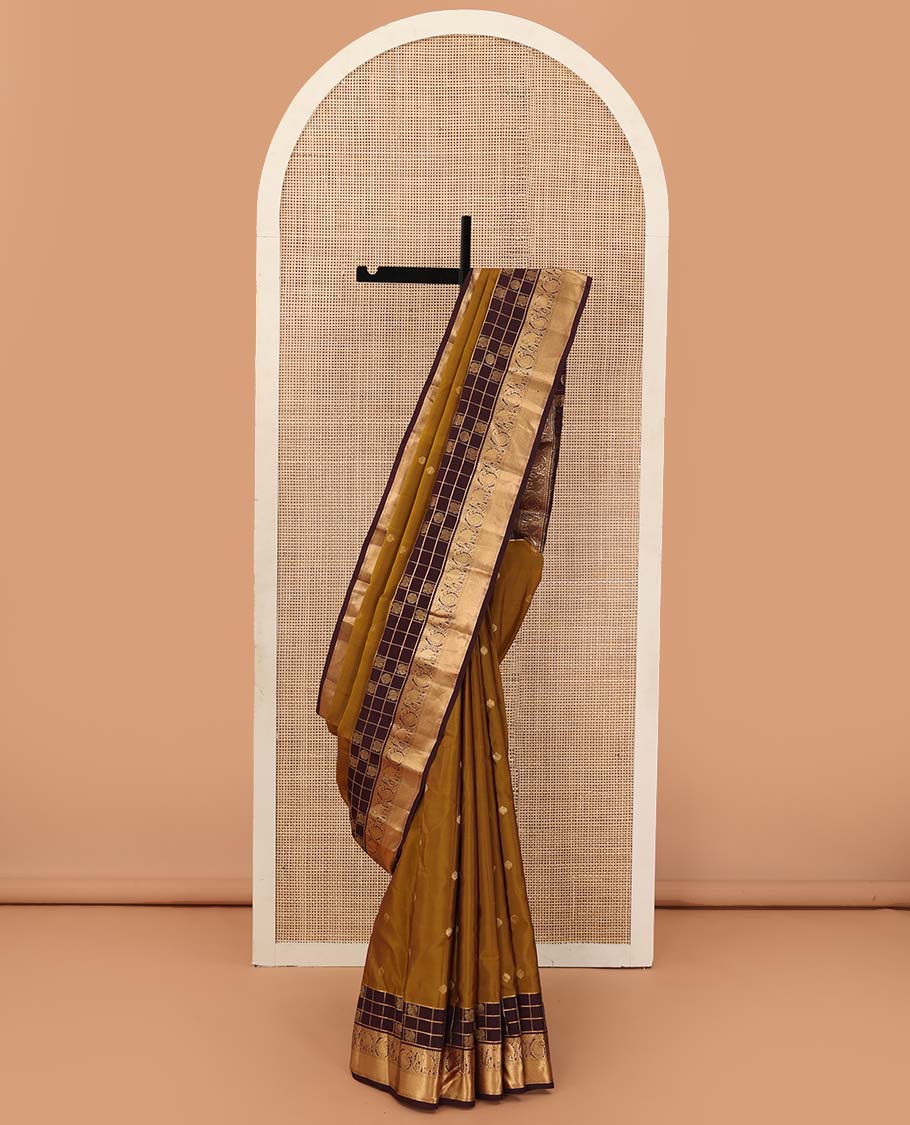 Mustard zari buttas Vasundhara silk mix saree, contrast annam chakram enclosed zari checked border of rekku, kamalam, arumbu manga, and yaanai, and jaal pallu