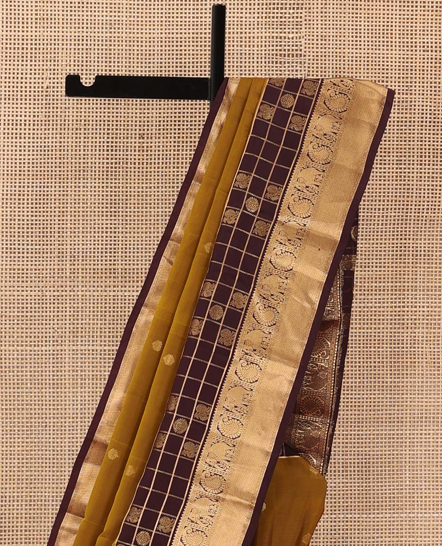 Mustard zari buttas Vasundhara silk mix saree, contrast annam chakram enclosed zari checked border of rekku, kamalam, arumbu manga, and yaanai, and jaal pallu