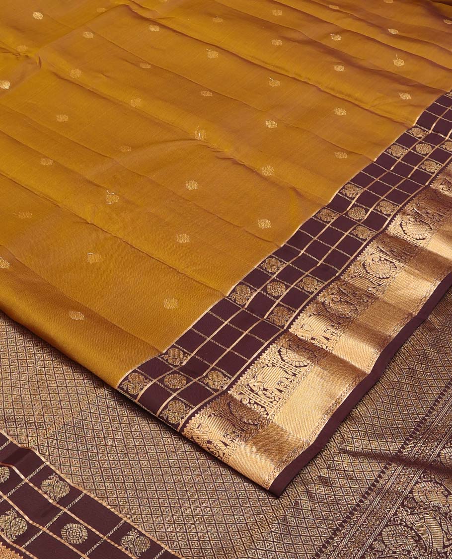 Mustard zari buttas Vasundhara silk mix saree, contrast annam chakram enclosed zari checked border of rekku, kamalam, arumbu manga, and yaanai, and jaal pallu