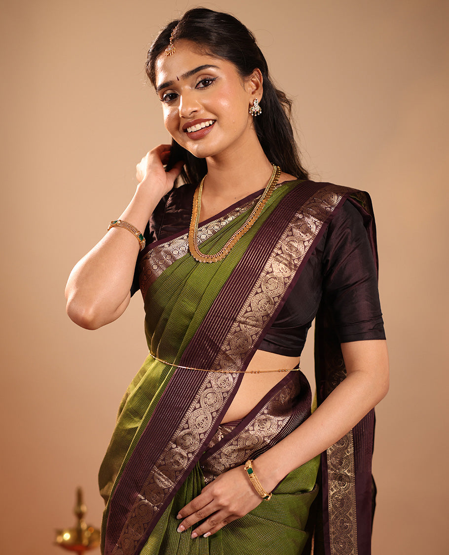 Green Vasundhara Silk Saree Mesmerized with Zari Micro-Checks All Over Its Body, Complemented by a Contrast Border of Rekku, Kamalam, Mayil Kann, Yaanai and Mayil Designs, Subtly Sparkled Pallu of Jaal Designs, and Paired with a Contrast Blouse