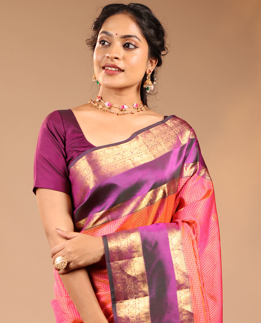 Orange Vasundhara Silk Saree Featuring Zari Checks and Annam Chakram Buttas, Complemented by a Contrast Rettai Pettu Border with Muthu, Yaali, and Kodi Visiry Designs, a Jaal Pallu, and a Contrast Zari-Bordered Blouse