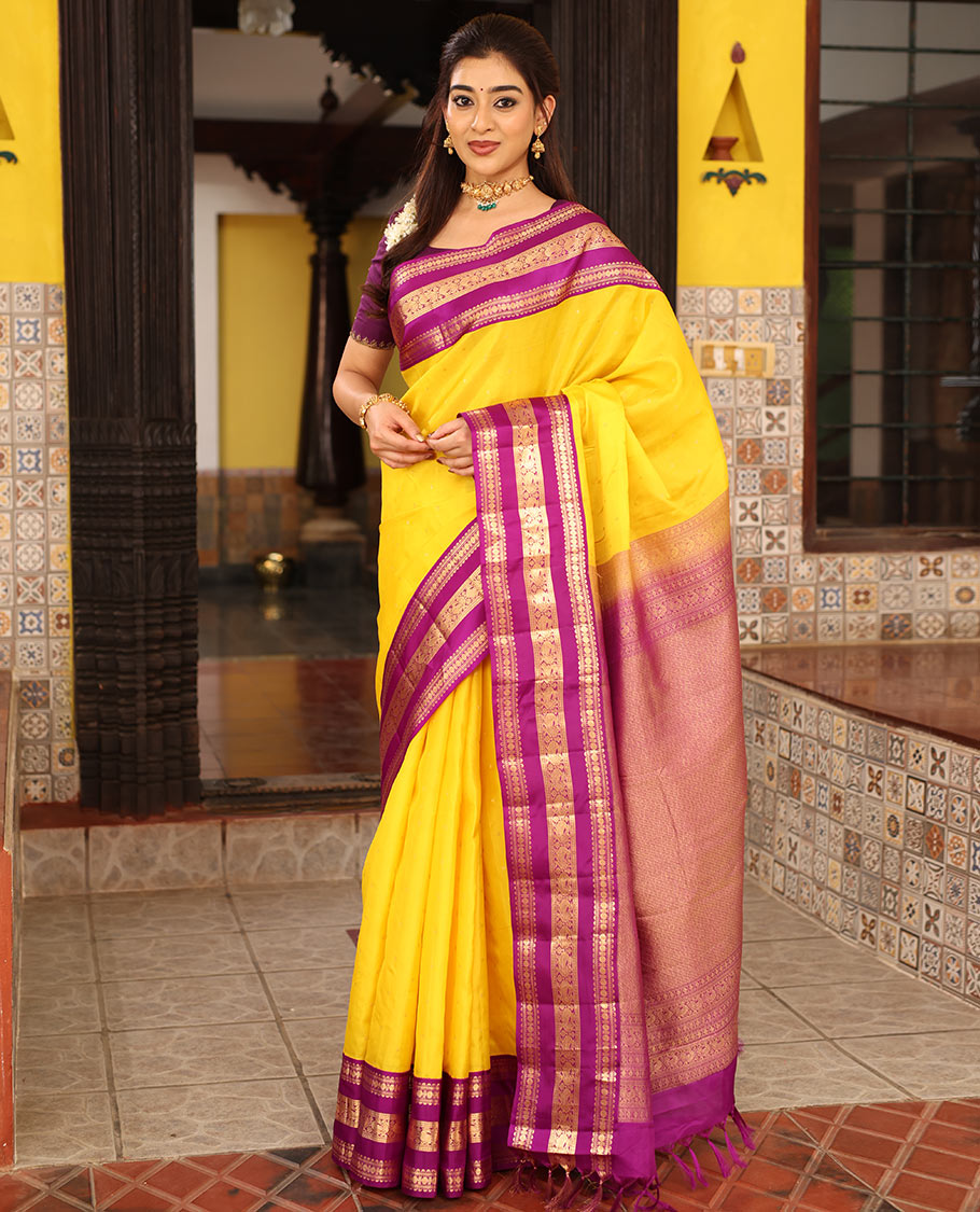 Yellow Vasundhara Silk Saree Finely Woven with Zari Buttas, Complemented with Varisai Pettu Border Featuring Rekku, Muthu, Banaras, Rudraksham, and Mayil Designs, Majestically Zari-Woven Pallu, and a Contrast Blouse