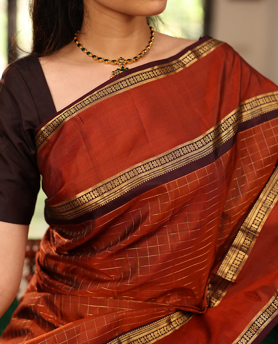 Rust Orange Kanchipuram Soft Silk Saree Graced with Medium-sized Zari Checks, Complemented by a Contrast Rettai Pettu Border of Rekku, Banaras, Kathir, and Star Vanki Designs, Pallu Elevated with Zari Designs, and Paired with a Contrast Blouse