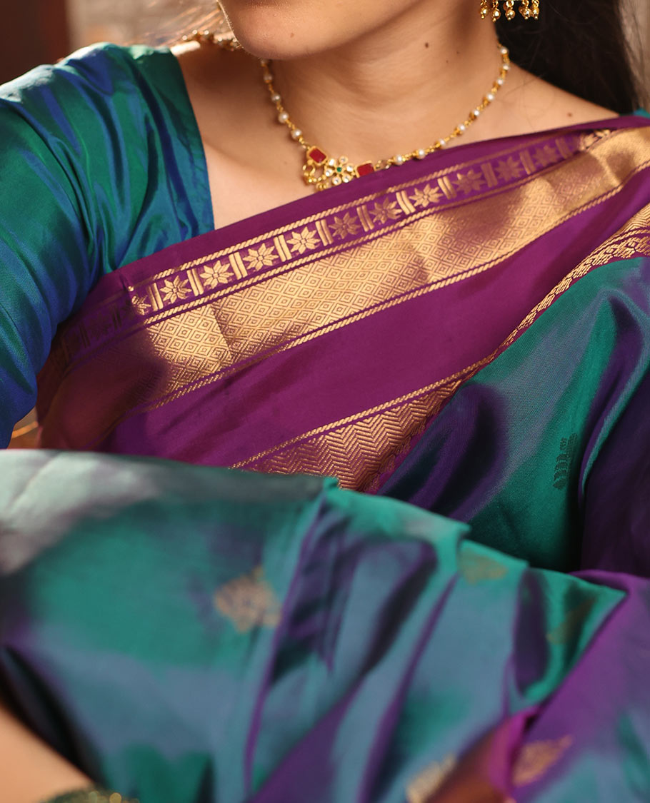 Blue Vasundhara Silk Saree Decked with Zari Buttas, Delicately Woven with a Contrast Rettai Pettu Border Featuring Thilakam Mokku, Vanki, Mayil Kann, and Star Motifs, a Majestically Woven Jaal-Designed Pallu, Paired with a Zari-Designed Blouse