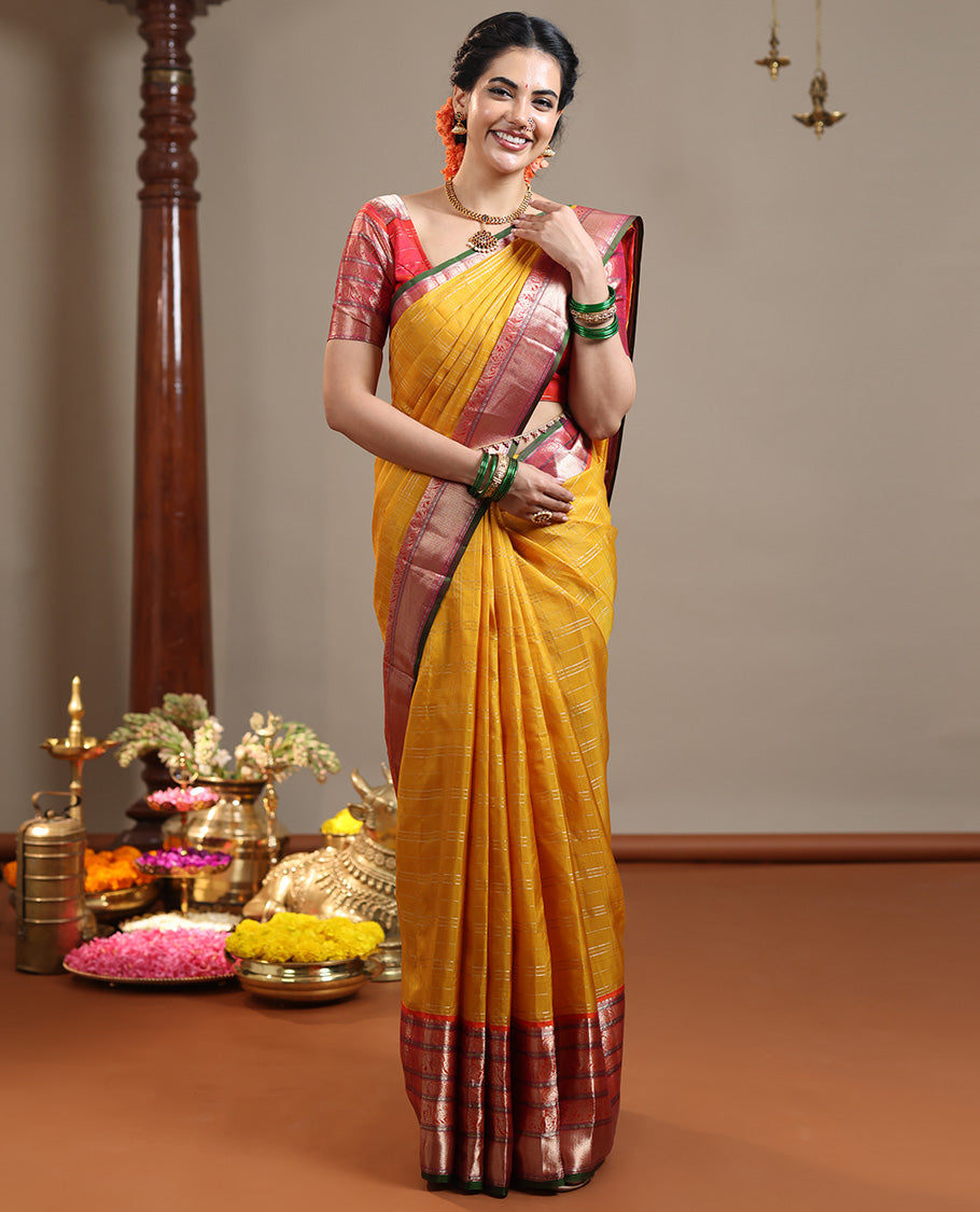 Mustard zari checked Vasundhara silk saree, contrast border of thilakam mokku, chakram, kodi yaanai, kuthirai, and mayil kann designs, intricate pallu, and zari design blouse