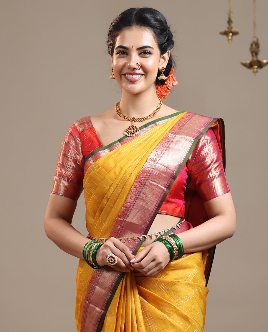 Mustard zari checked Vasundhara silk saree, contrast border of thilakam mokku, chakram, kodi yaanai, kuthirai, and mayil kann designs, intricate pallu, and zari design blouse