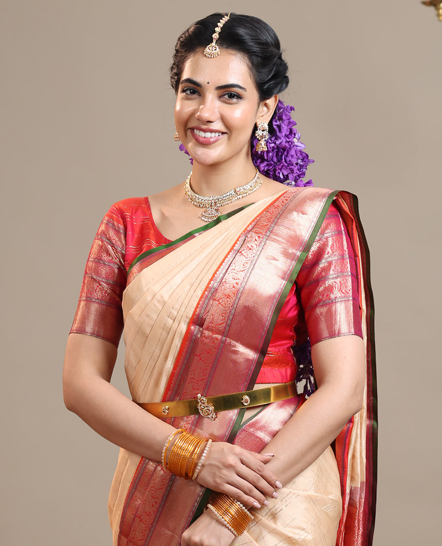Sandal Vasundhara Silk Saree Subtly Sparkled with Zari Checks, Complemented by a Contrast Border of Thilakam Mokku, Chakram, Kodi Yaanai, Kuthirai, and Mayil Kann, Intricately Designed Pallu, and Paired with a Contrast Blouse