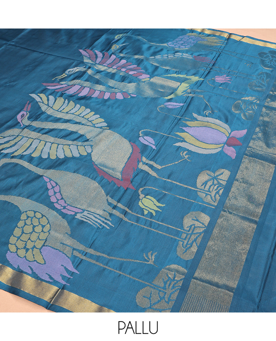 Blue Uppada Silk Saree, Elevated with Meena Flora-Fauna Designs, a Zari Border, and a Plain Blouse