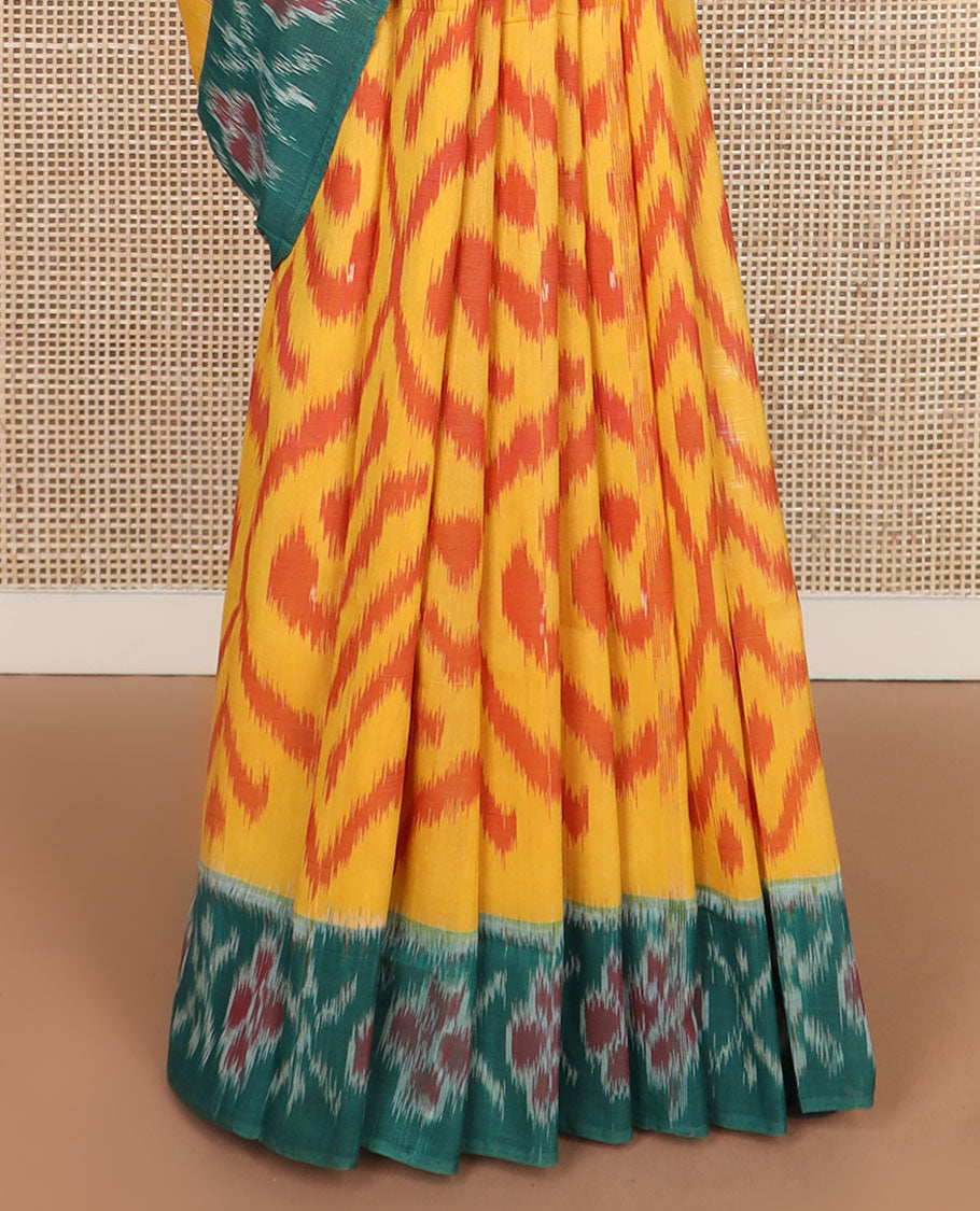 Yellow ogee-patterned ikkat cotton saree, contrast cross & floral motifs ikat border & ikkat design pallu