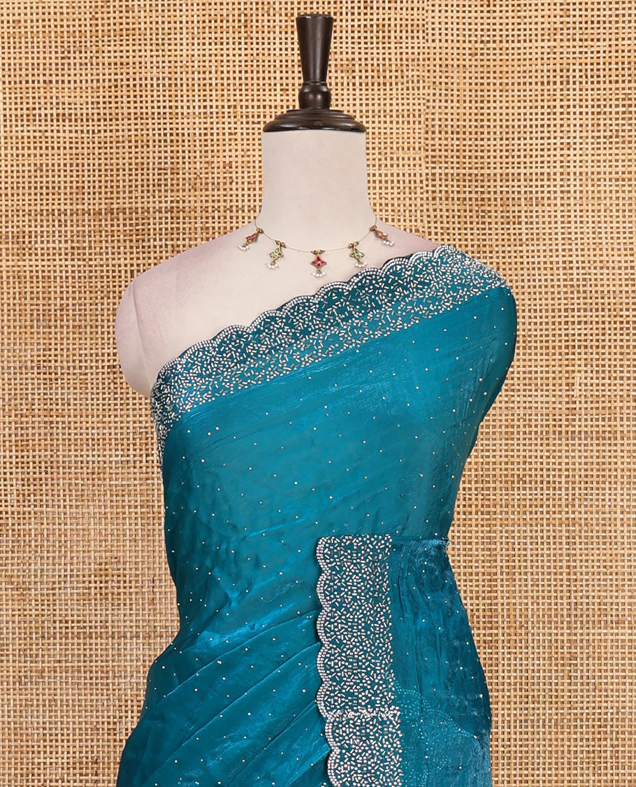 Rama blue Swarovski crystal stone embedded fendy chiffon saree, scallop Swarovski stone embroidered border, and contrast plain blouse