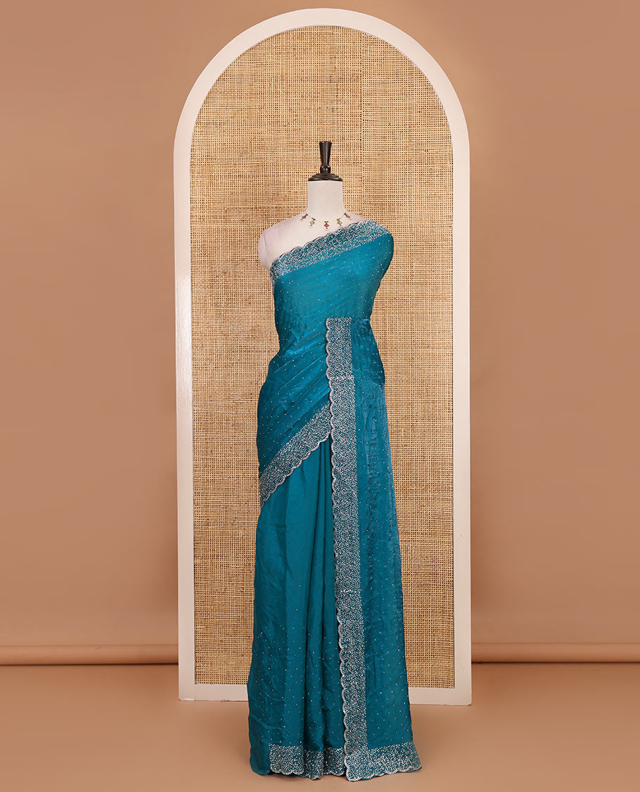 Rama blue Swarovski crystal stone embedded fendy chiffon saree, scallop Swarovski stone embroidered border, and contrast plain blouse