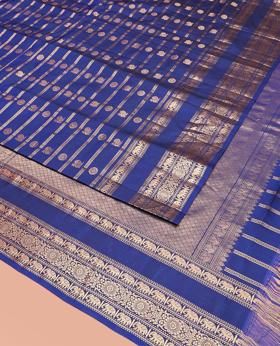 Blue Vasundhara Silk Saree Adorned with Zari Stripes and Annam Chakram Buttas, Highlighted by a Zari Border of Ara Bogudi, Muthu, Banaras, Yaanai, and Chakram Designs, a Zari-Woven Pallu of Jaal Designs, and Paired with a Matching Blouse