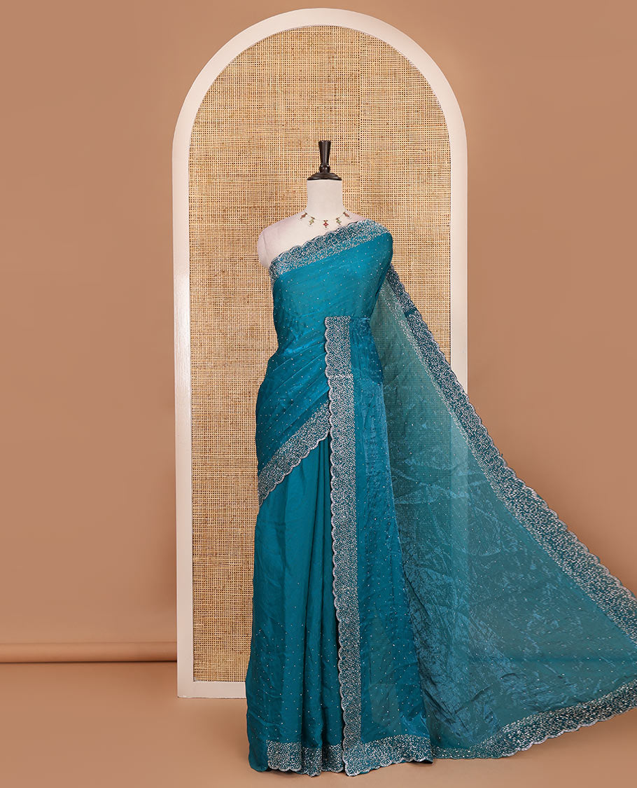 Rama blue Swarovski crystal stone embedded fendy chiffon saree, scallop Swarovski stone embroidered border, and contrast plain blouse