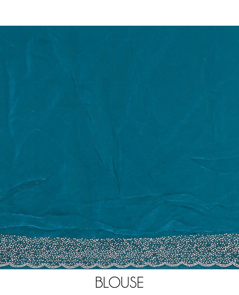 Rama blue Swarovski crystal stone embedded fendy chiffon saree, scallop Swarovski stone embroidered border, and contrast plain blouse