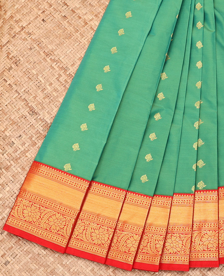 Green Budget Silk Saree, Artfully Detailed with Zari Buttas All Over Its Body, Complemented by a Contrast Traditional Zari Design Border, Pallu of Floral Designs, and Paired with a Contrast Blouse