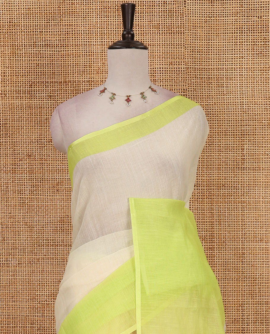 Cream full-plain linen saree, contrast parrot green big plain border, plain pallu & buttas printed matching blouse