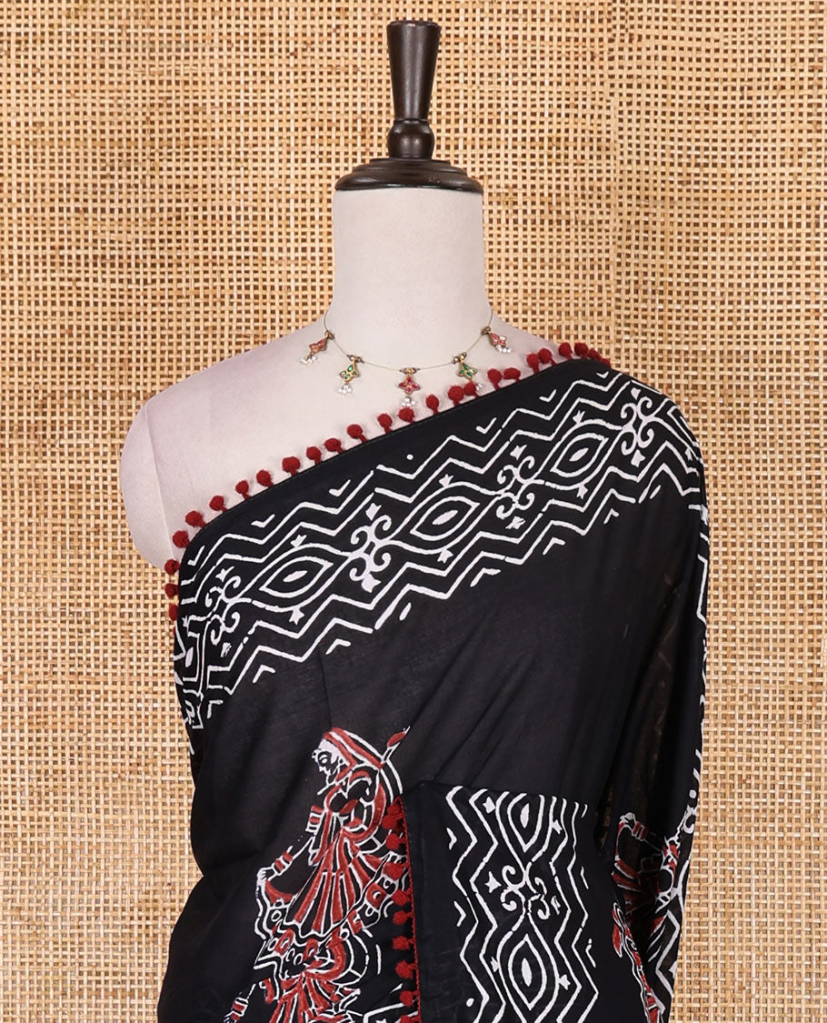 Black dancing girl motif printed soft cotton saree, batik printed pom-pom tasseled border, bird motifs printed pallu, and matching blouse