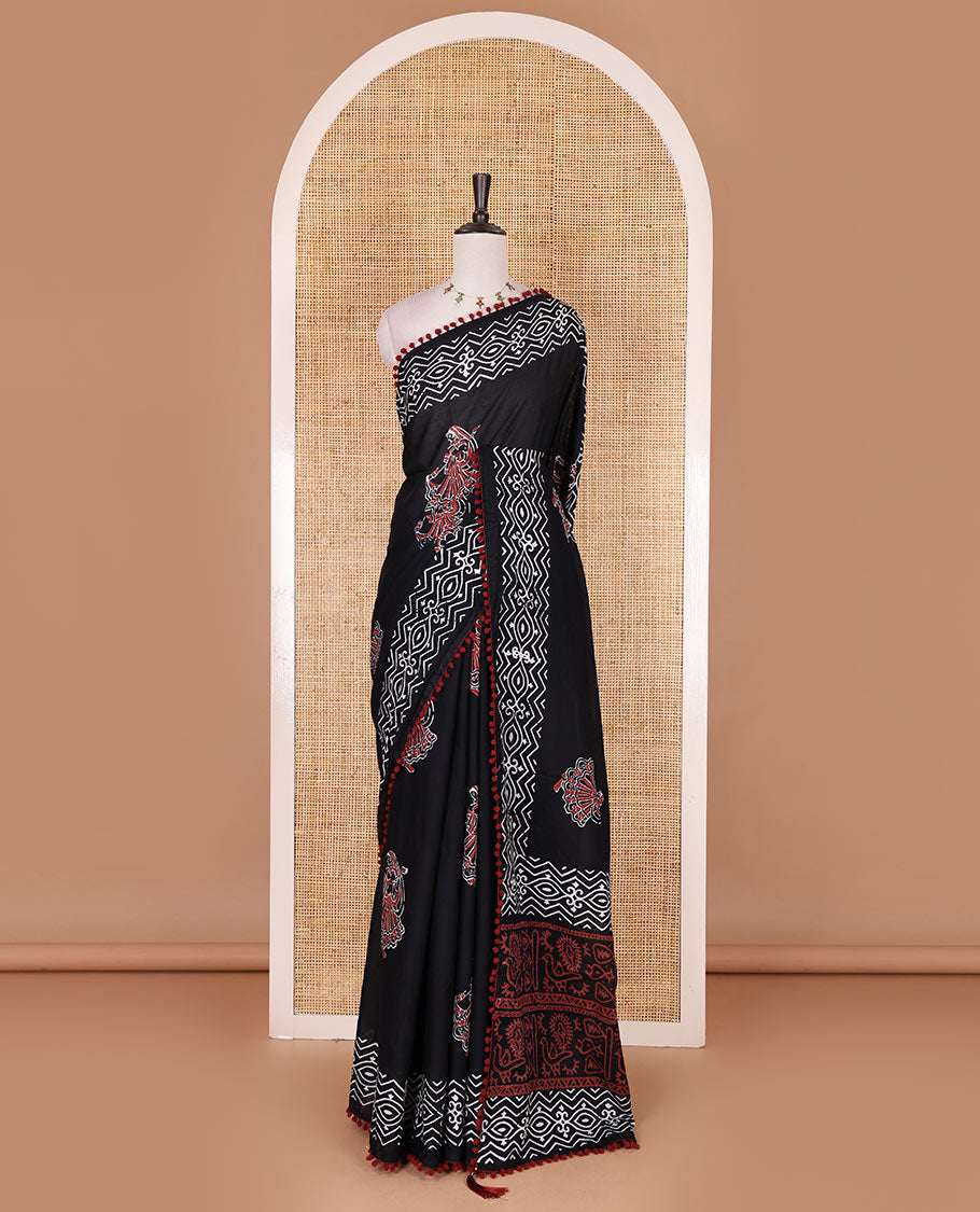 Black dancing girl motif printed soft cotton saree, batik printed pom-pom tasseled border, bird motifs printed pallu, and matching blouse