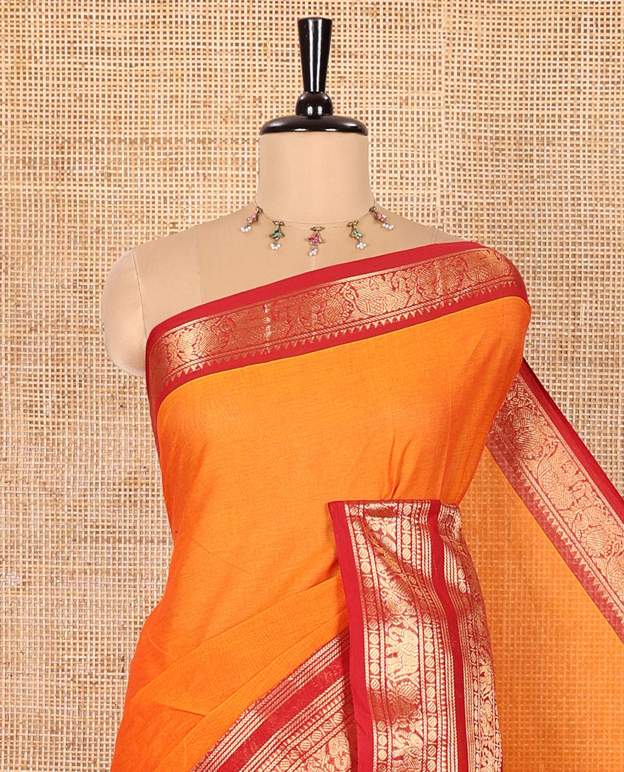 Orange Plain Chettinad Cotton Saree, Complemented by Contrast Traditional Zari Varisai Pettu Border of Peacock and Elephant Designs, Subtly Striped Pallu, and Paired with a Matching Blouse