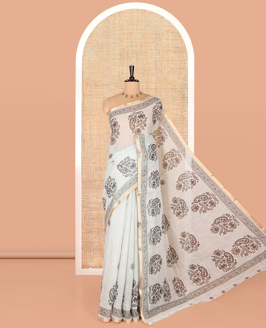 Pista Linen Cotton Saree, Bedecked with Floral-Paisley Motifs Print All Over Its Body, Highlighted by Gold Zari Printed Border, Floral-Paisley Printed Pallu and Paired with a Matching Blouse