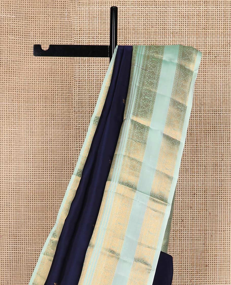 Blue zari buttas Vasundhara silk mix saree, contrast rettai pettu border of thilakam, muthu, neli, and mayil designs, and intricate pallu