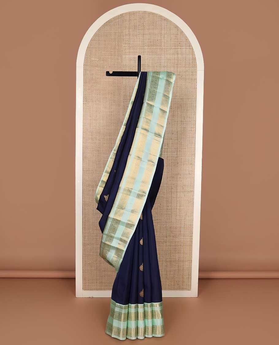 Blue zari buttas Vasundhara silk mix saree, contrast rettai pettu border of thilakam, muthu, neli, and mayil designs, and intricate pallu