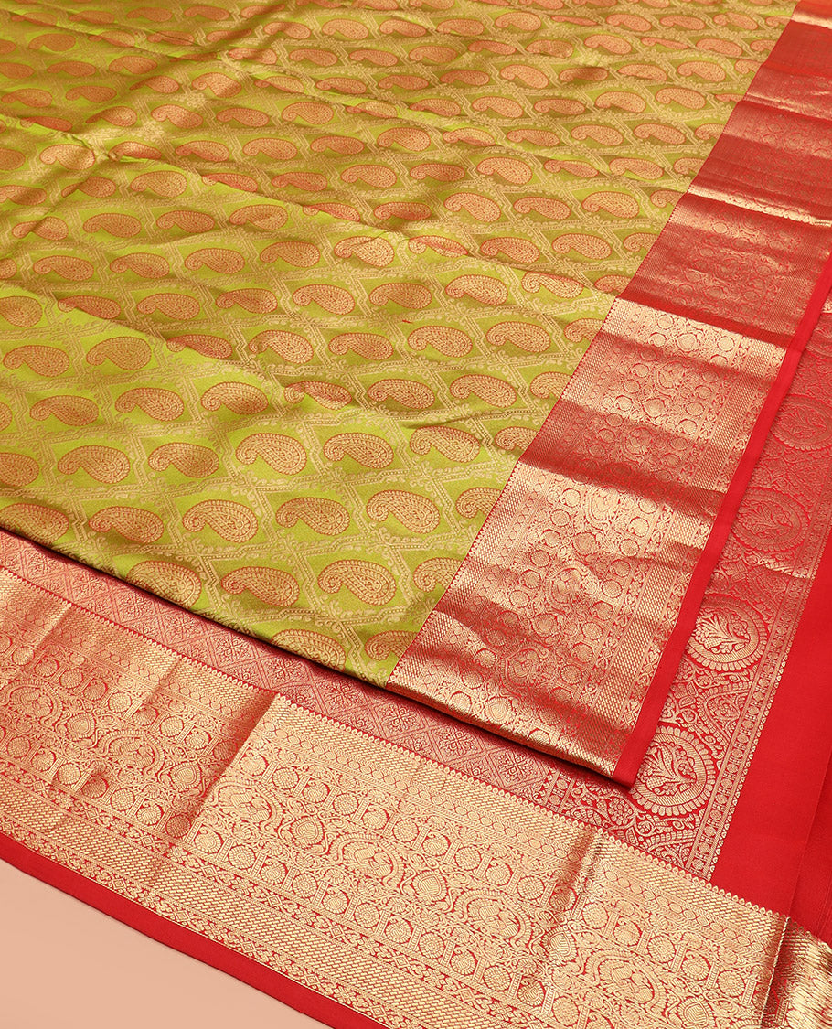 Green Kanchipuram Silk Saree Delicately Woven with Manga Jacquard Design, Complemented by Contrast Border of Thilakam, Chakram, Manga, Kodi Visiry, Mayil, and Jada Nagam Designs, Pallu Gleamed Up with Jaal Designs, and Paired with a Contrast Blouse