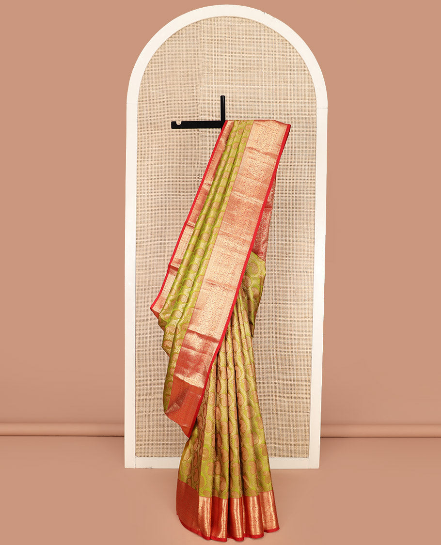 Green Kanchipuram Silk Saree Delicately Woven with Manga Jacquard Design, Complemented by Contrast Border of Thilakam, Chakram, Manga, Kodi Visiry, Mayil, and Jada Nagam Designs, Pallu Gleamed Up with Jaal Designs, and Paired with a Contrast Blouse