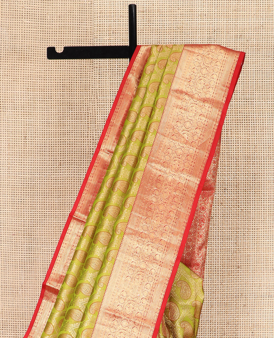 Green Kanchipuram Silk Saree Delicately Woven with Manga Jacquard Design, Complemented by Contrast Border of Thilakam, Chakram, Manga, Kodi Visiry, Mayil, and Jada Nagam Designs, Pallu Gleamed Up with Jaal Designs, and Paired with a Contrast Blouse