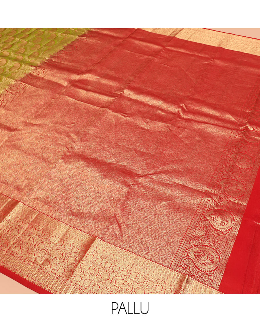 Green Kanchipuram Silk Saree Delicately Woven with Manga Jacquard Design, Complemented by Contrast Border of Thilakam, Chakram, Manga, Kodi Visiry, Mayil, and Jada Nagam Designs, Pallu Gleamed Up with Jaal Designs, and Paired with a Contrast Blouse