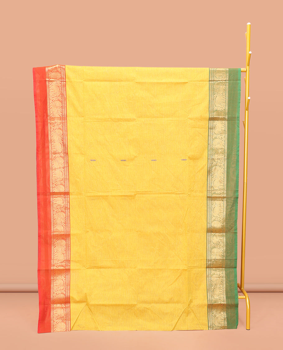 Yellow Chettinad Cotton Saree, Finely Crafted with Thread Buttas All Over Its Body, Complemented by a Contrast Ganga-Jamuna Kal Eragina Border of Kodi Peacock and Elephant Designs, Pallu of Buttas and Stripes, and Paired with a Matching Blouse