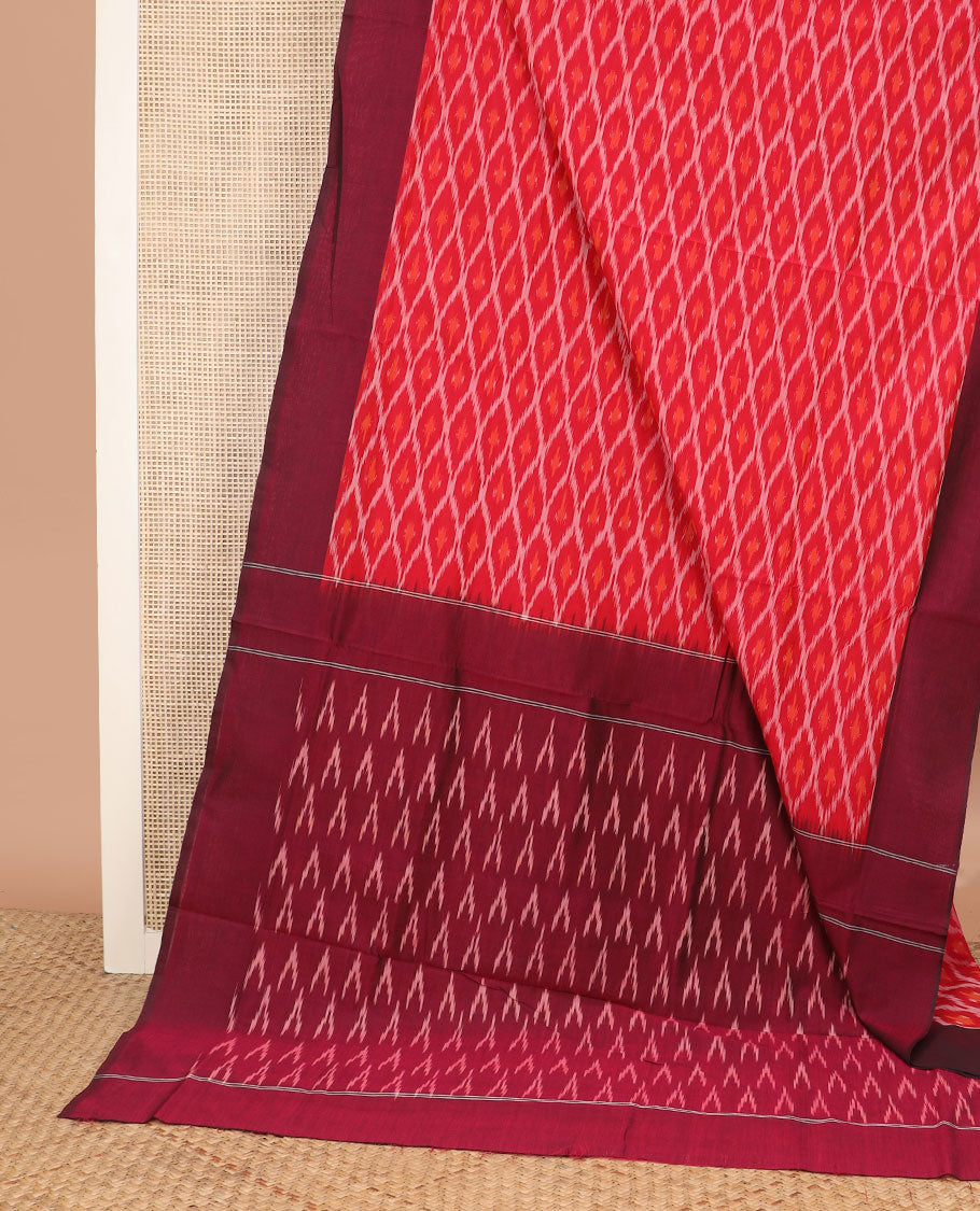 Red Ikkat Cotton Saree Delicately Woven with Ogee Patterns in Ikkat Weave, Complemented by a Contrast Plain Border, and Pallu Featuring Ikkat Buttas