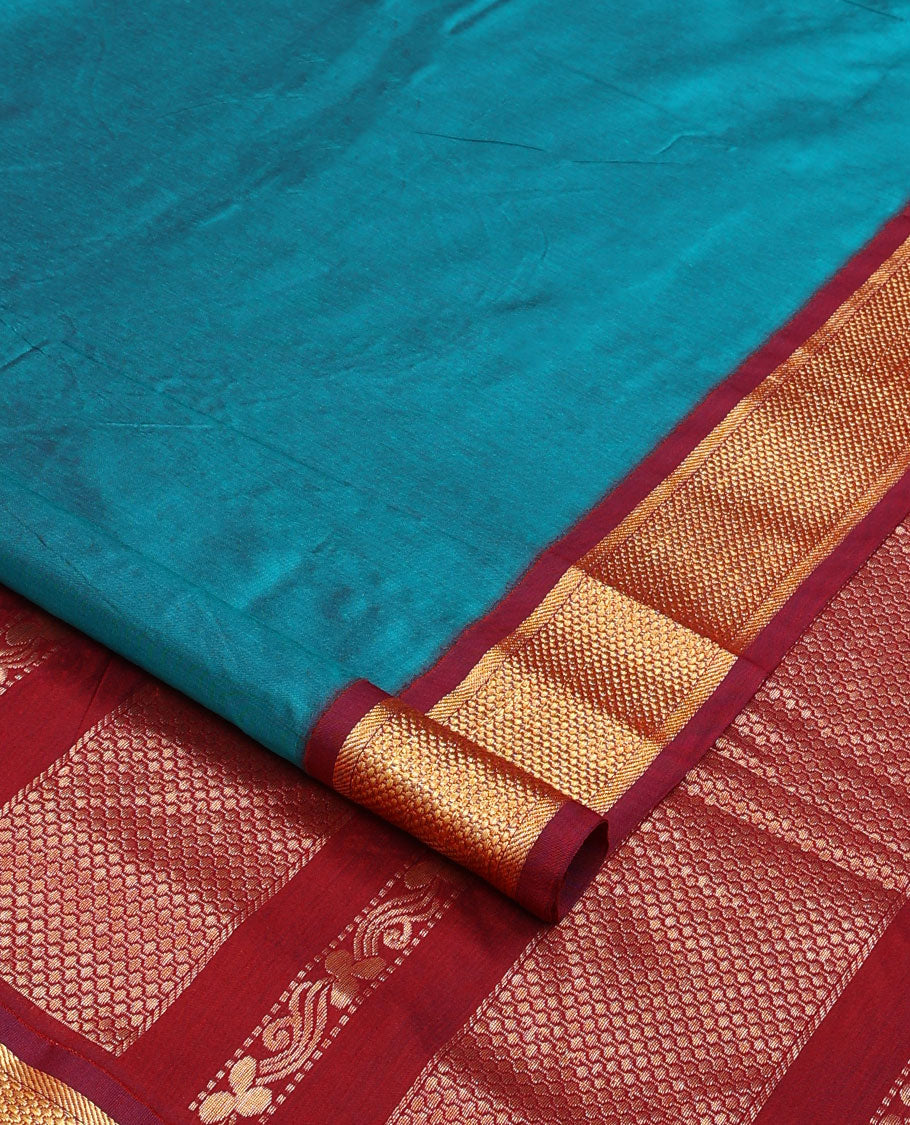 Blue plain nine-yard cotton saree, contrast traditional zari border, and pallu of traditional designs