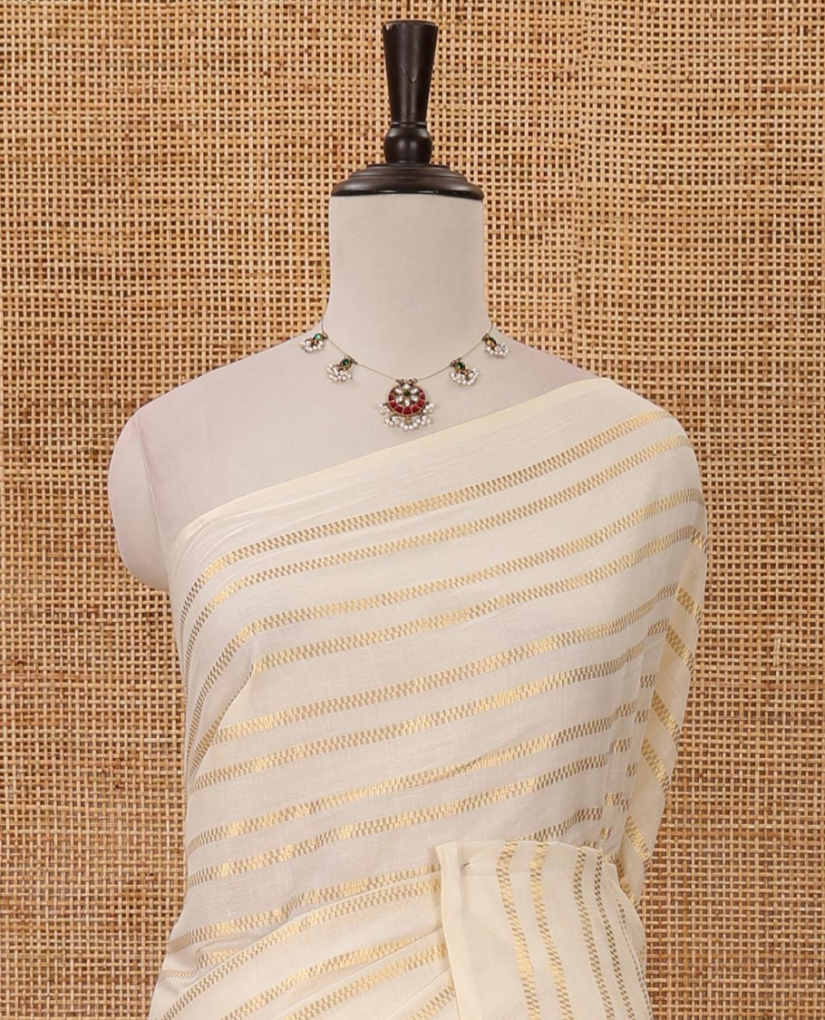 Borderless cream Veldhari-style striped Kerala cotton saree, zari design pallu with maroon tussels & zari design blouse